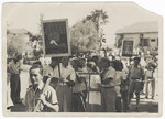Members of a Shomer Hatzair Kibbutz, Gan Shmuel, parade on May Day with tools and banners illustrating their occupations.