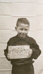 Michael Jontscharon holds a name card intended to help any of his surviving family members locate him at the Kloster Indersdorf DP camp.