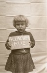 Eliz Allacher holds a name card intended to help any of her surviving family members locate her at the Kloster Indersdorf DP camp.