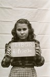 Elfriede Libor holds a name card intended to help any of her surviving family members locate her at the Kloster Indersdorf DP camp.