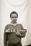 Tadeusz Wojcik holds a name card intended to help any of his surviving family members locate him at the Kloster Indersdorf DP camp.