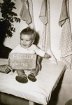 Infant Anna Pedruk with a name card intended to help any of her surviving family members locate her at the Kloster Indersdorf DP camp.