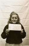 Ursel Tilke holds a name card intended to help any of her surviving family members locate her at the Kloster Indersdorf DP camp.