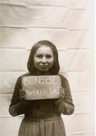 Wanda Bunzol holds a name card intended to help any of her surviving family members locate her at the Kloster Indersdorf DP camp.