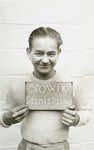 Stanislaw Stowik holds a name card intended to help any of his surviving family members locate him at the Kloster Indersdorf DP camp.
