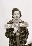Nelli Jussem holds a name card intended to help any of her surviving family members locate her at the Kloster Indersdorf DP camp.