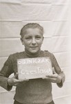 Czeslaw Olejniczak holds a name card intended to help any of his surviving family members locate him at the Kloster Indersdorf DP camp.