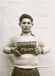 Moses Beserman holds a name card intended to help any of his surviving family members locate him at the Kloster Indersdorf DP camp.