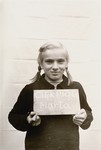 Marta Cierpiol holds a name card intended to help any of her surviving family members locate her at the Kloster Indersdorf DP camp.