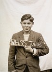 Julius Weiss holds a name card intended to help any of his surviving family members locate him at the Kloster Indersdorf DP camp.