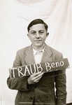 Beno Traub holds a name card intended to help any of his surviving family members locate him at the Kloster Indersdorf DP camp.