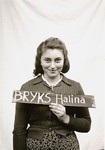 Halina Bryks holds a name card intended to help any of her surviving family members locate her at the Kloster Indersdorf DP camp.