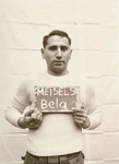 Bela Meisels holds a name card intended to help any of his surviving family members locate him at the Kloster Indersdorf DP camp.