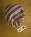 The cap of a prison uniform and a number patch worn by concentration camp prisoner Karel Bruml at Auschwitz and Nordhausen.
