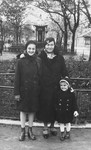Kitty Weichherz poses with her mother and her older cousin, Klari Neumann, in a park [probably in Bratislava].