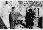 Varian Fry (left) views a Chagall painting outside the artist's home in Gordes.