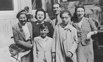 Two Dutch Jewish brothers pose with the woman who served as their surrogate mother in Theresienstadt and their cousins who cared for them after the war.