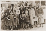Members of the Tuchsznajder family pose in front of a bus during a vacation in Kazimierz.