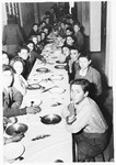 Jewish youth gather around a table to celebrate the Sabbath in the dining room of the Youth Aliyah children's home in Selvino, Italy.