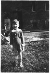 A young Jewish boy poses outside in the Rzeszow ghetto.