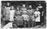 Mordechai and Sheindel Rajs pose outdoors with their six children.