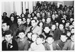 A large group of children crowds into the auditorium of the Selvino Youth Aliyah children's home.