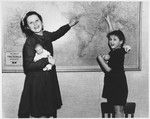 Two Jewish sisters, Dora and Marie Claire Rakowski point out their journey to America on a wall map soon after their immigration to the US.