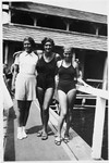 Three Austrian Jewish swimming champions pose outside the swimming area where they are training.