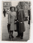 Street portrait of a Jewish couple in Belgium standing in front of a kiosk taken less than a year before they were deported to Auschwitz.
