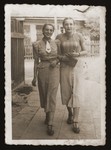 Two young Jewish women walk along a street in Chelm.