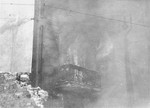 An apartment building razed by the SS burns during the suppression of the Warsaw ghetto uprising.