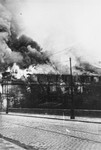 A building razed by the SS burns during the suppression of the Warsaw ghetto uprising.