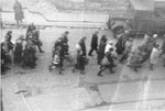 Jews captured by the SS during the suppression of the Warsaw ghetto uprising march down Nowolipie and Zelazna Street to the Umschlagplatz for deportation.