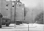 An apartment building razed by the SS burns during the suppression of the Warsaw ghetto uprising.