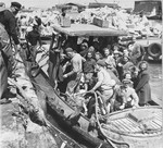 A group of children survivors from the Bergen-Belsen displaced persons' camp are brought to shore in Tel Aviv, after having been detained in refugee camps in Cyprus.