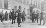 SS and police officers look on as SS Major General Juergen Stroop discusses razing the houses on Niska and Muranowska Streets with Kaleschke, his police adjutant.