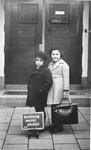 Portrait of two Jewish girls at the entrance to their school on their first day of classes.
