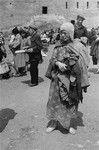A barefoot woman at an outdoor market in the Warsaw ghetto.