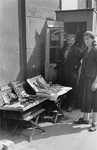 Street vendors stand next to their display tables in the Warsaw ghetto.