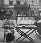 A cigarette and match vendor on Zelazna Street in the Warsaw ghetto.