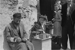 A Jewish man and youth sell bread on the street in the Warsaw ghetto.