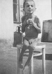 A starving child poses on a stool in a hospital in the Warsaw ghetto.