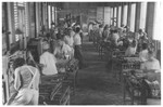 Jewish refugees work in a straw factory making handbags for export to America.