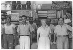 Group portrait of the staff of the El Colmado general store in Sosua.