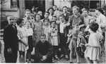Anny (Hubner) Andermann (in the polka dot dress) poses with a group of Jewish orphans who were recently repatriated from Transnistria.