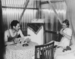 A young couple sits in their hut in Tel Shachar and reads and knits.