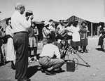 Henry Morgenthau Jr. takes photographs of new immigrants in Tel Shachar while Robert Capa films the same scene for his 1951 documentary, "The Journey".
