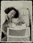 Beila Gaikowski poses next to the cradle of her newborn son Yitzhakl.
