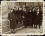 Chaim Paikowski (far left)  stands on a wooden bridge with a group of friends.
