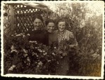 Three young women stand in the gazebo in the Kabacznik family's flower garden.